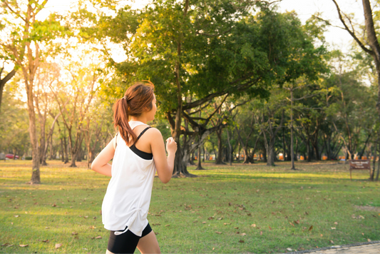 Women running during golden hour in a park