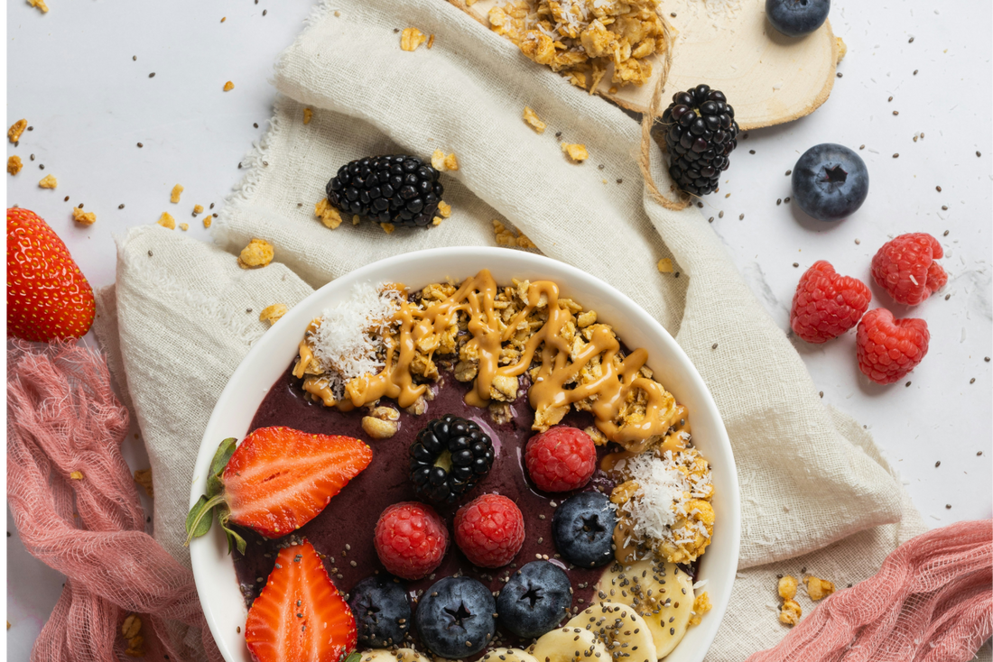 smoothie bowl with strawberries, granola, blueberries and coconut flakes