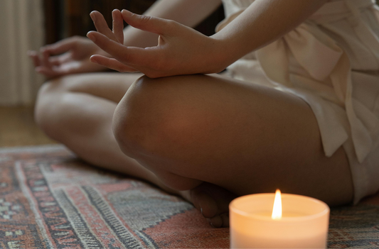 Person with candle meditating 